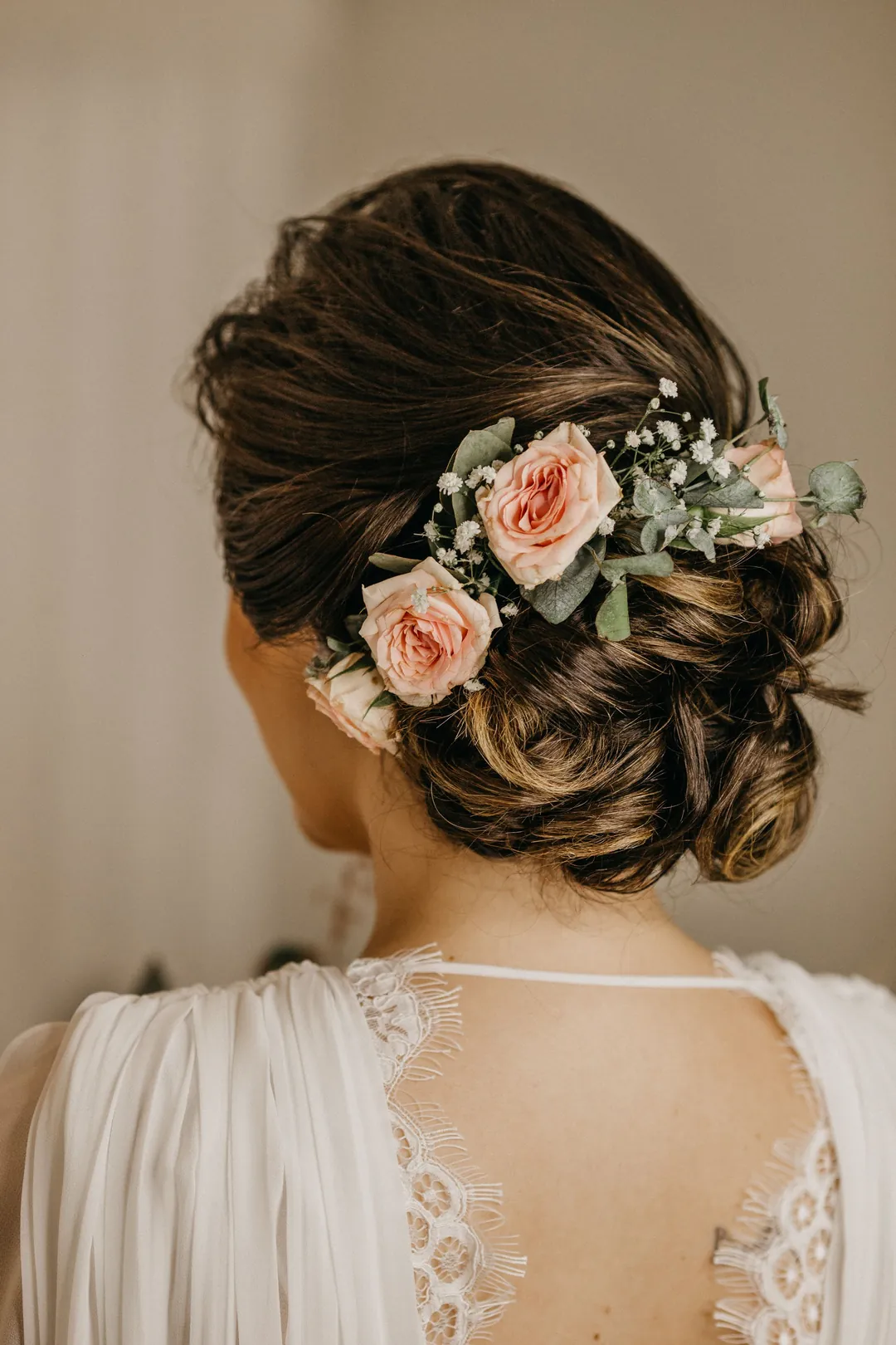 A low chignon finished with roses