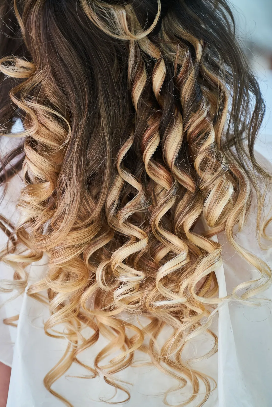Long spiral curls, dark to golden at the ends