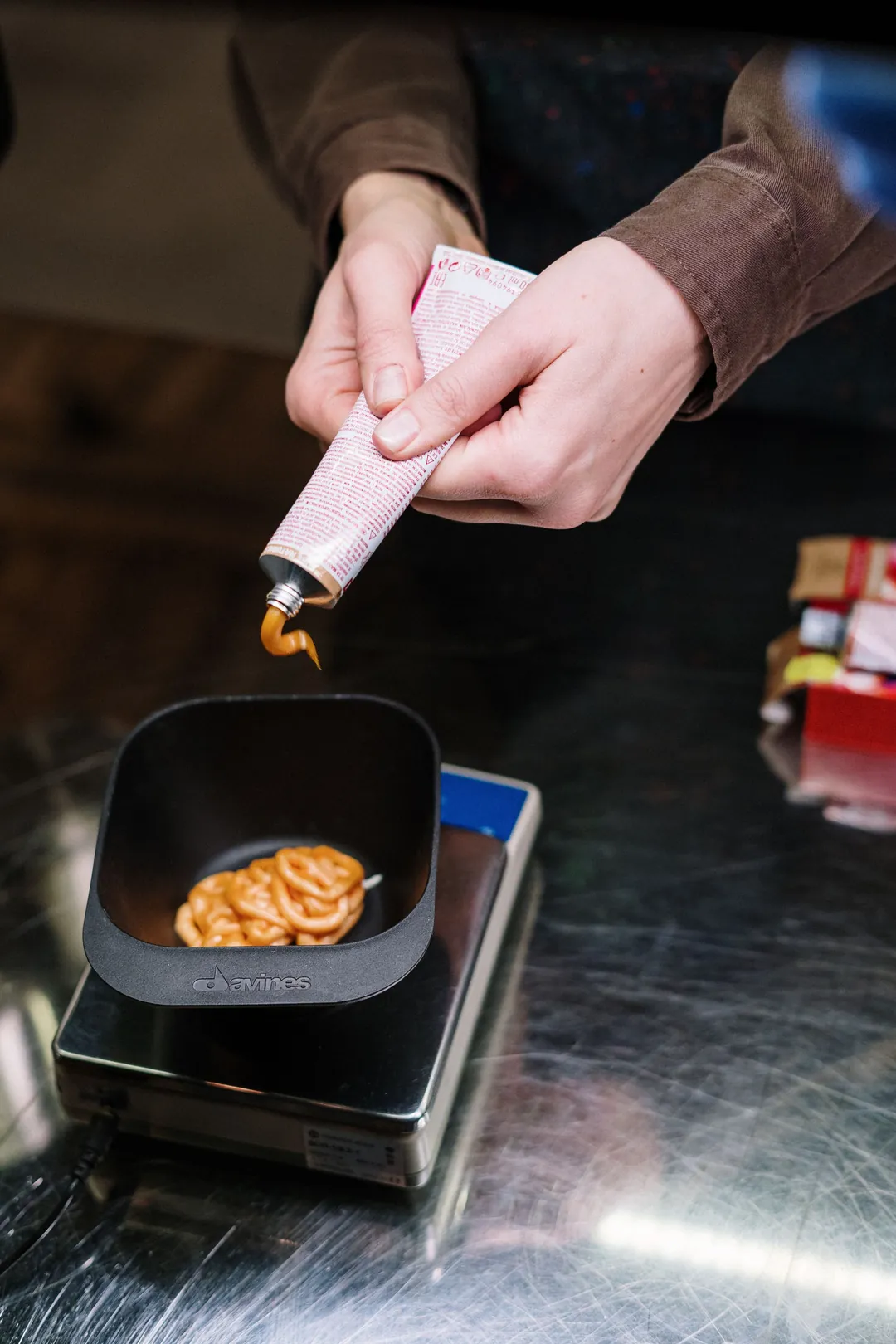 Colour being squeezed into a bowl on salon scales