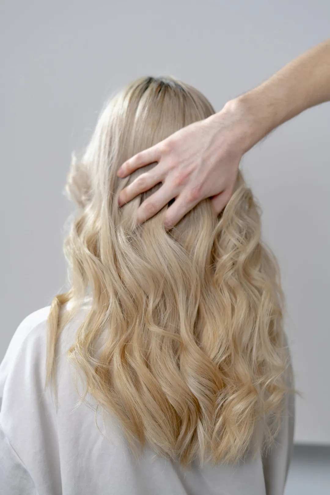 Long blonde waves seen from behind