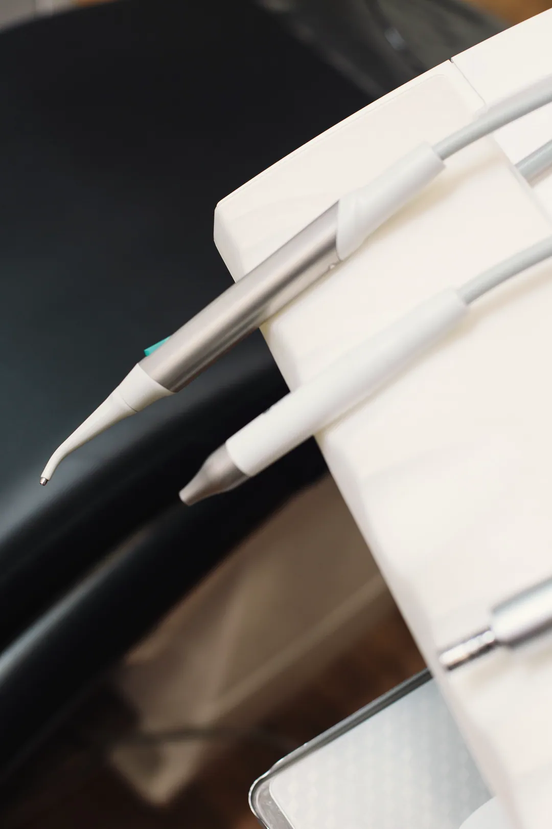Ultrasonic scaler and air-water tips rest in the delivery unit holder