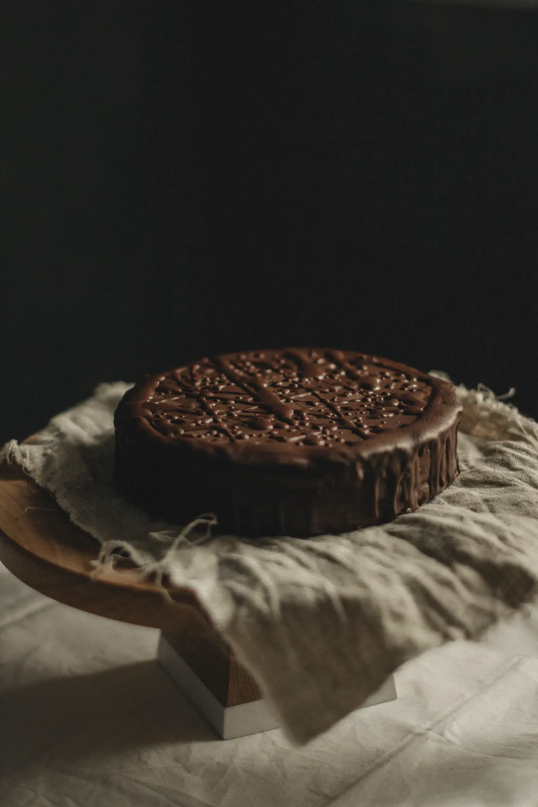 A dark chocolate cake on linen