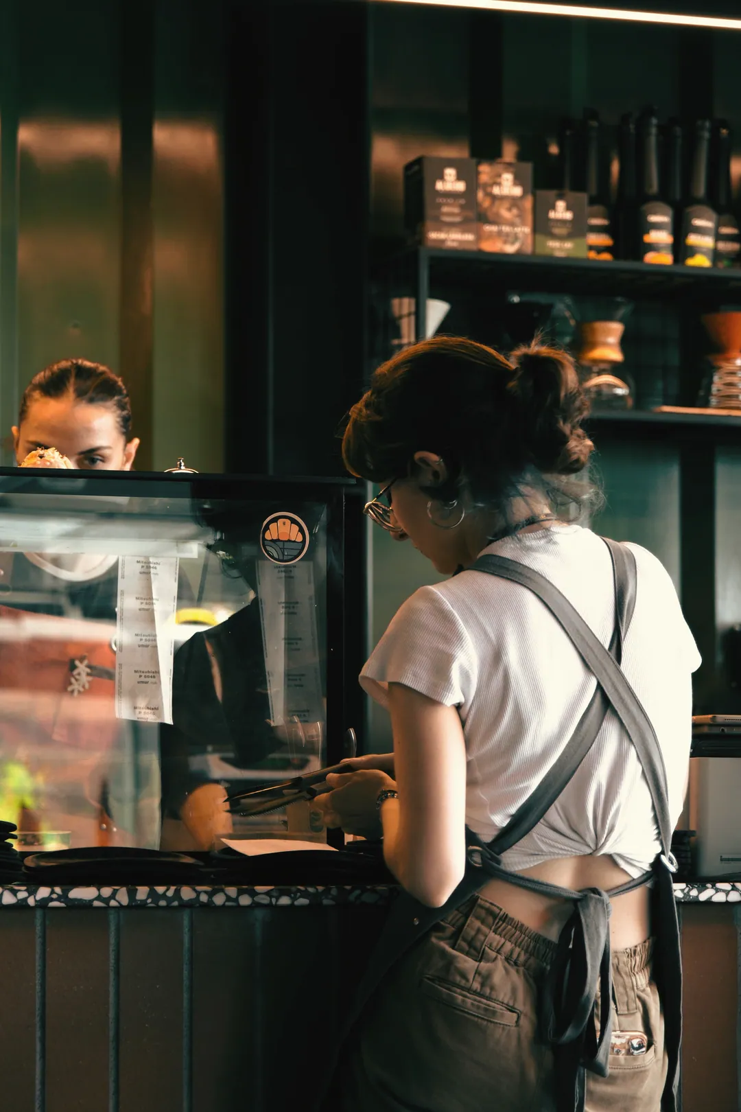 Someone working the counter, seen from behind