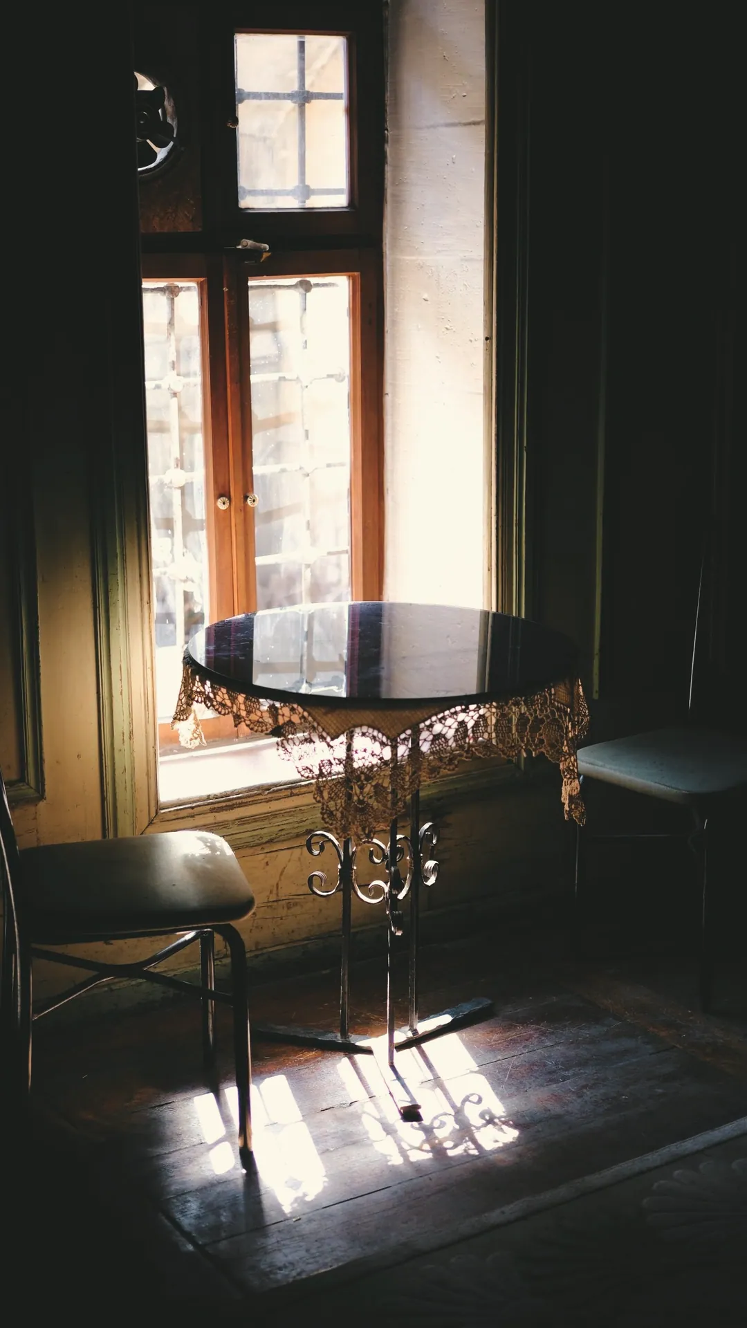 Sun across a small table by a tall window