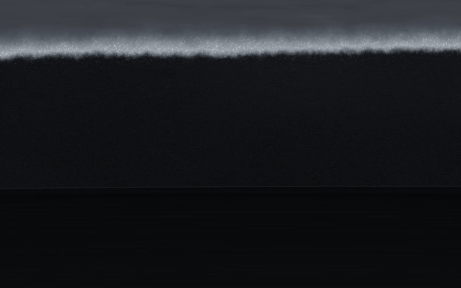 Polished steel seen edge-first: the white hardened edge at the top, dark grained steel below.