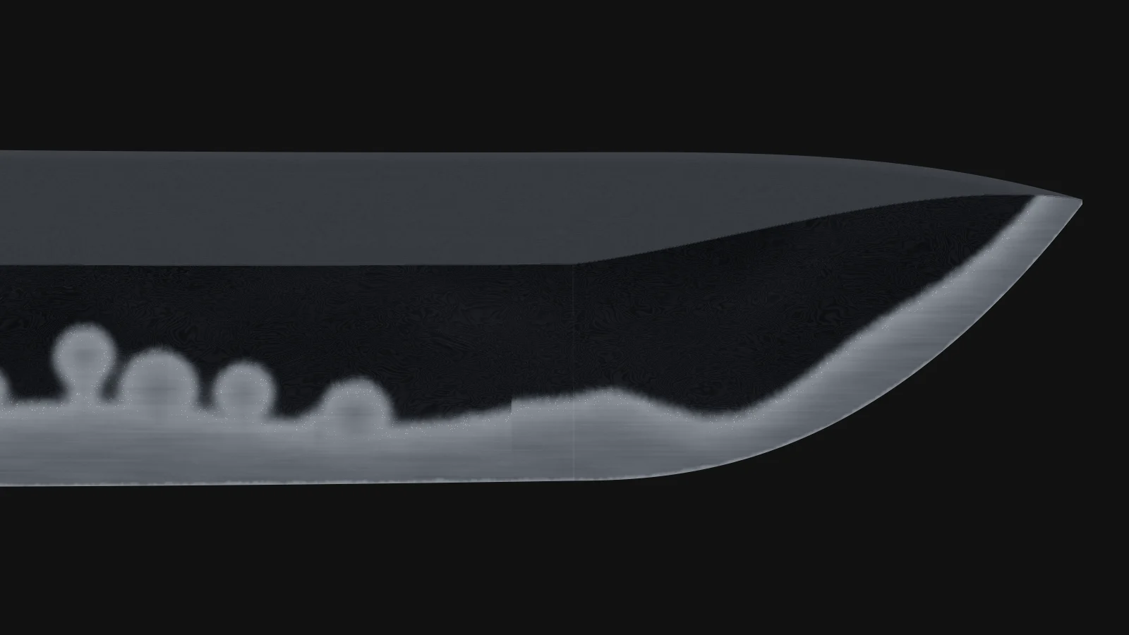 Nugui: A paste of iron oxide in oil darkens the ji to blue-black so the hamon reads.