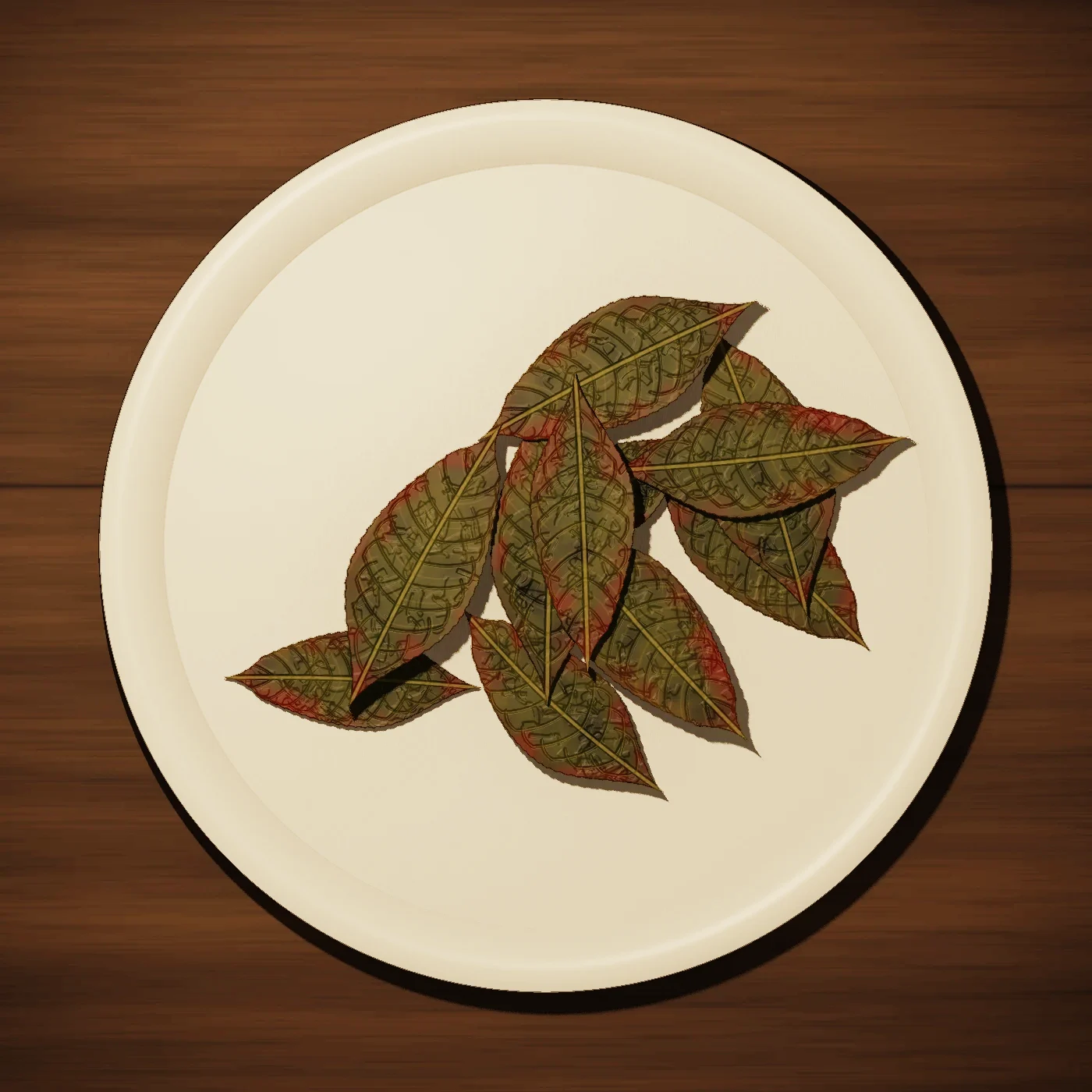 Spent tea leaves spread on a white plate, green with red-brown edges