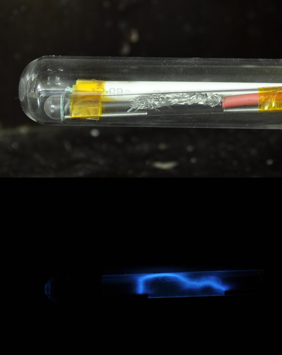 Light from a struck quartz crystal, photographed in the dark.