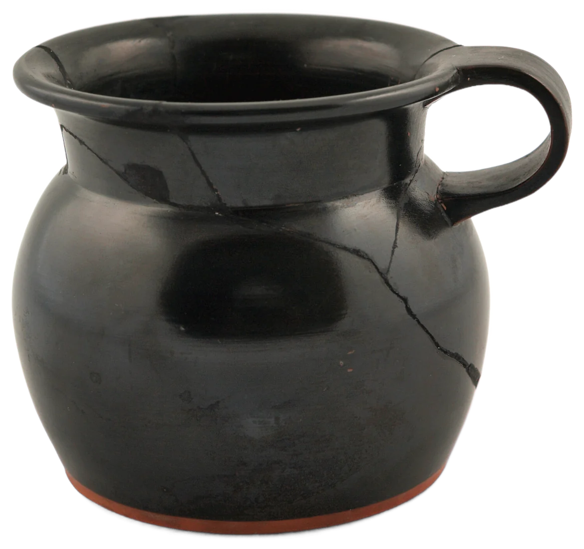 Nell's first auction lot, a mended black jug. It holds the pencils by the till and isn't for sale.