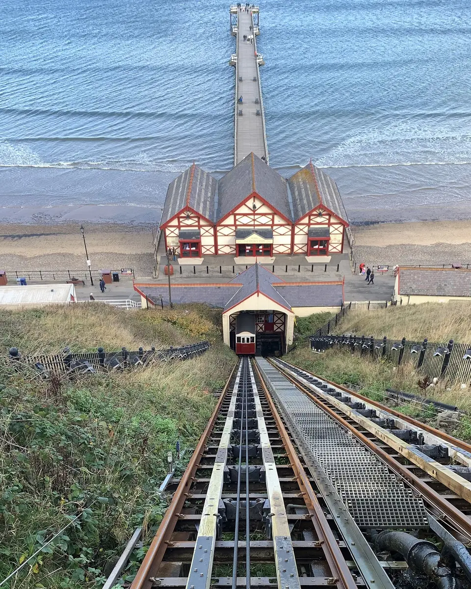 Looking down the tracks of Saltburn's cliff lift to the pier and the sea