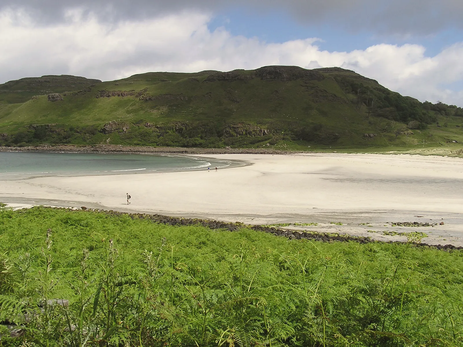 The white sand of Calgary Bay with machair and green hills behind