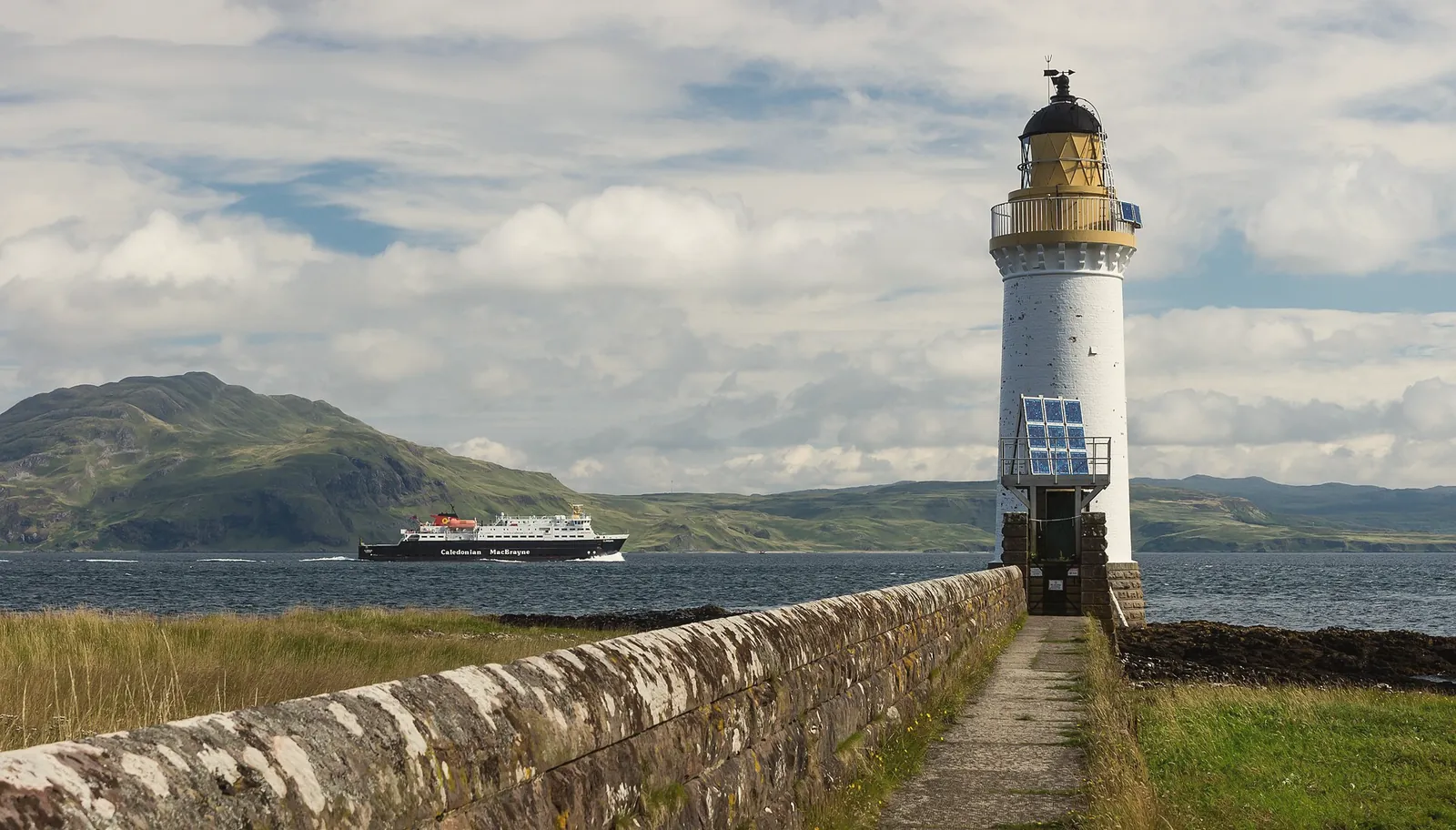 Rubha nan Gall lighthouse north of Tobermory, with a CalMac ferry passing