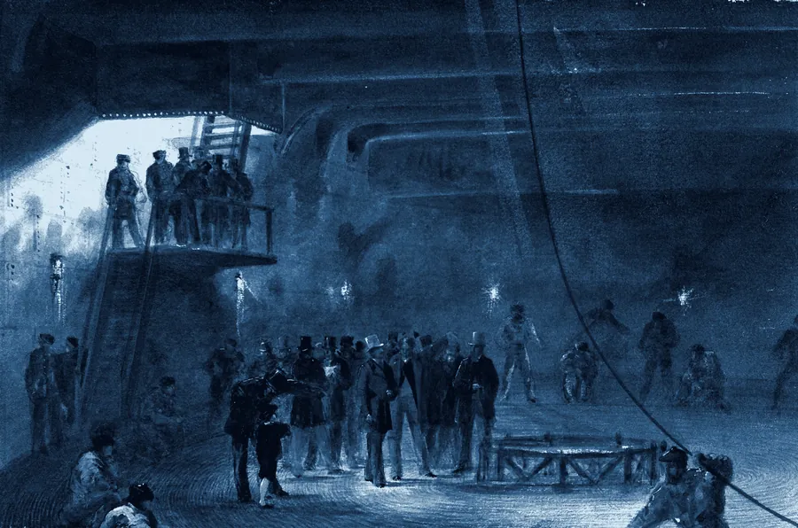 Lamplit cable tank below deck on the Great Eastern, men coiling cable around the central cone.