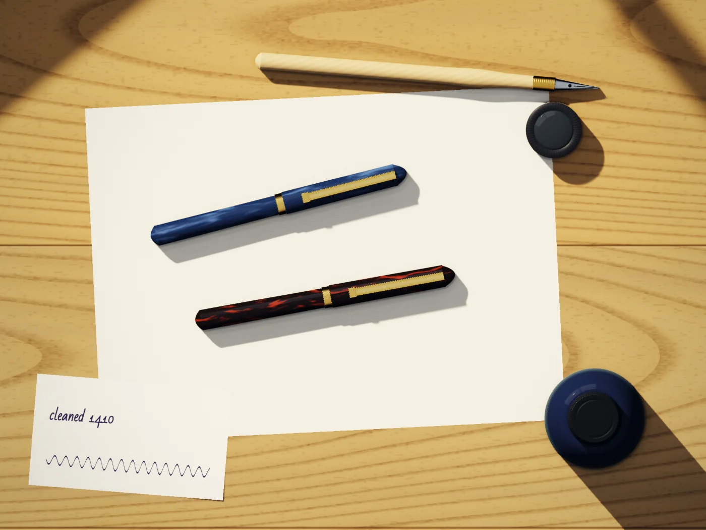 Dan’s tray: two fountain pens, a loupe, an ink bottle, a dip pen and a strip of test paper