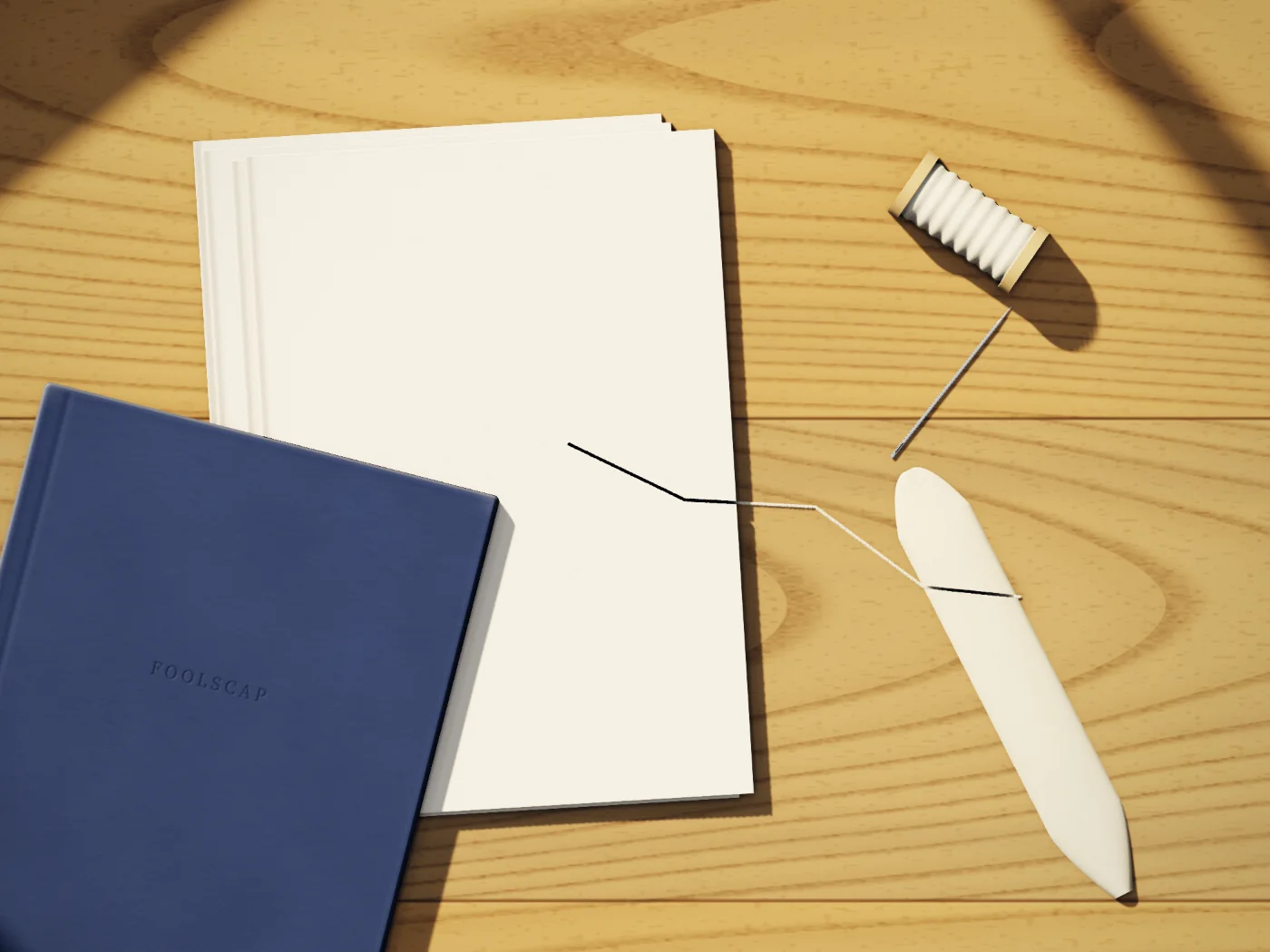 Ruth’s bench: folded signatures of laid paper, linen thread and a needle, a bone folder and a finished navy notebook