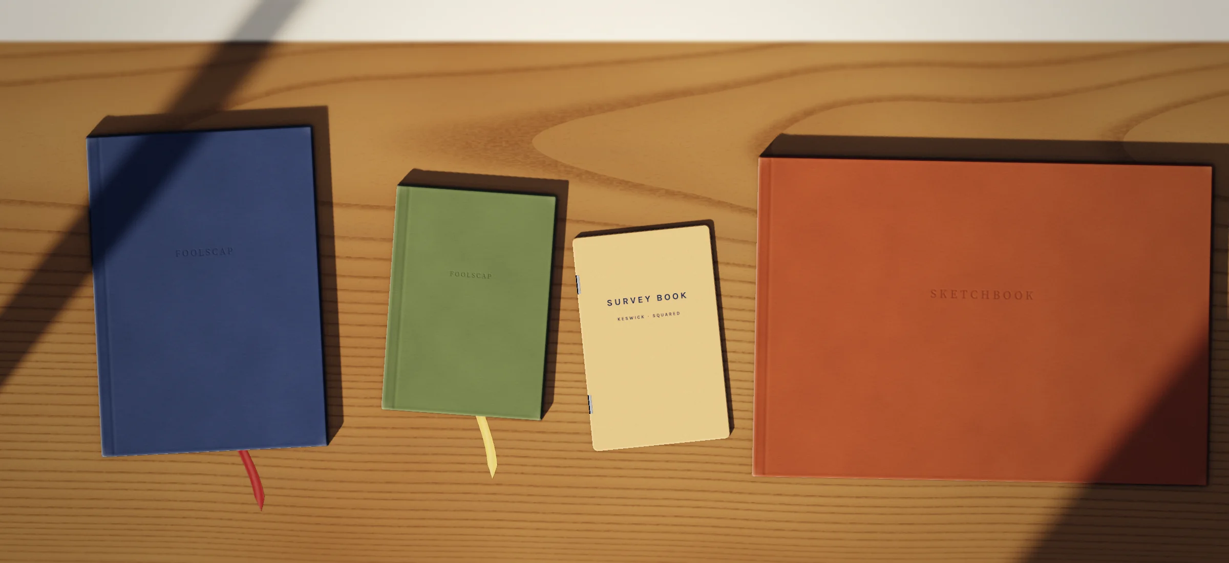 Notebooks on the shelf: askew notebook, plain, askew notebook, dotted, survey book, sketchbook