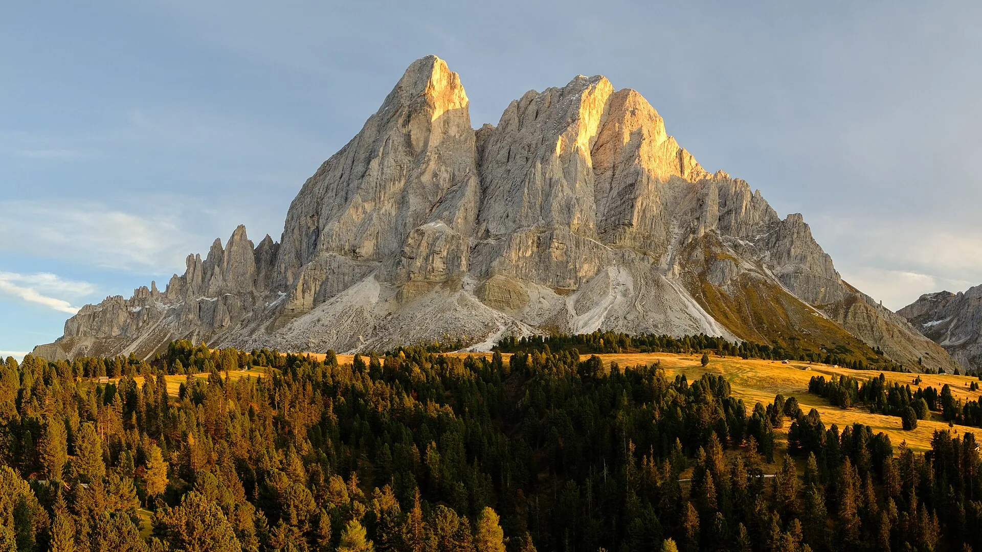 Larches turned gold below the Peitlerkofel, the rock lit by the last sun.