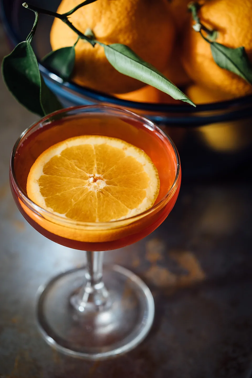 An orange aperitivo in a coupe with a slice of orange