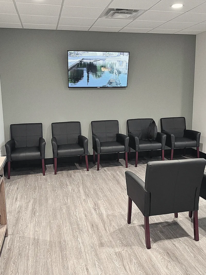 A quiet waiting room with a row of armchairs