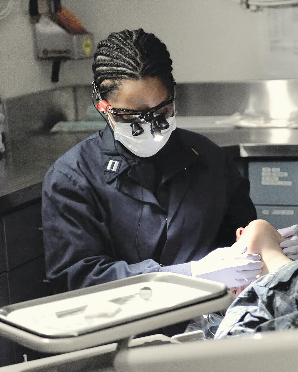 Dr. Clara Hale at the chair, loupes on