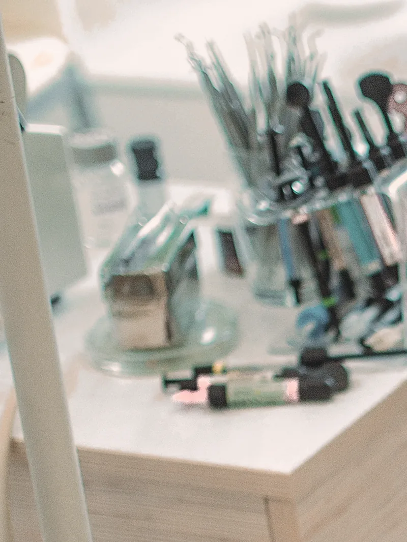 Burs and hand instruments standing ready on the side table of a treatment room