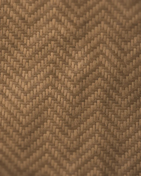 The herringbone cloth of No. 18 seen close: brown and camel wool yarns in a twill that turns back on itself