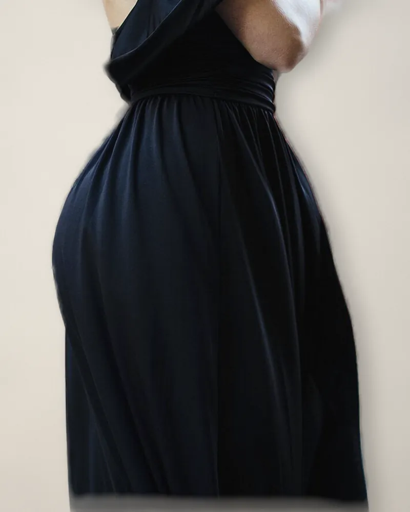 A long black crepe dress with a low, wrapped back