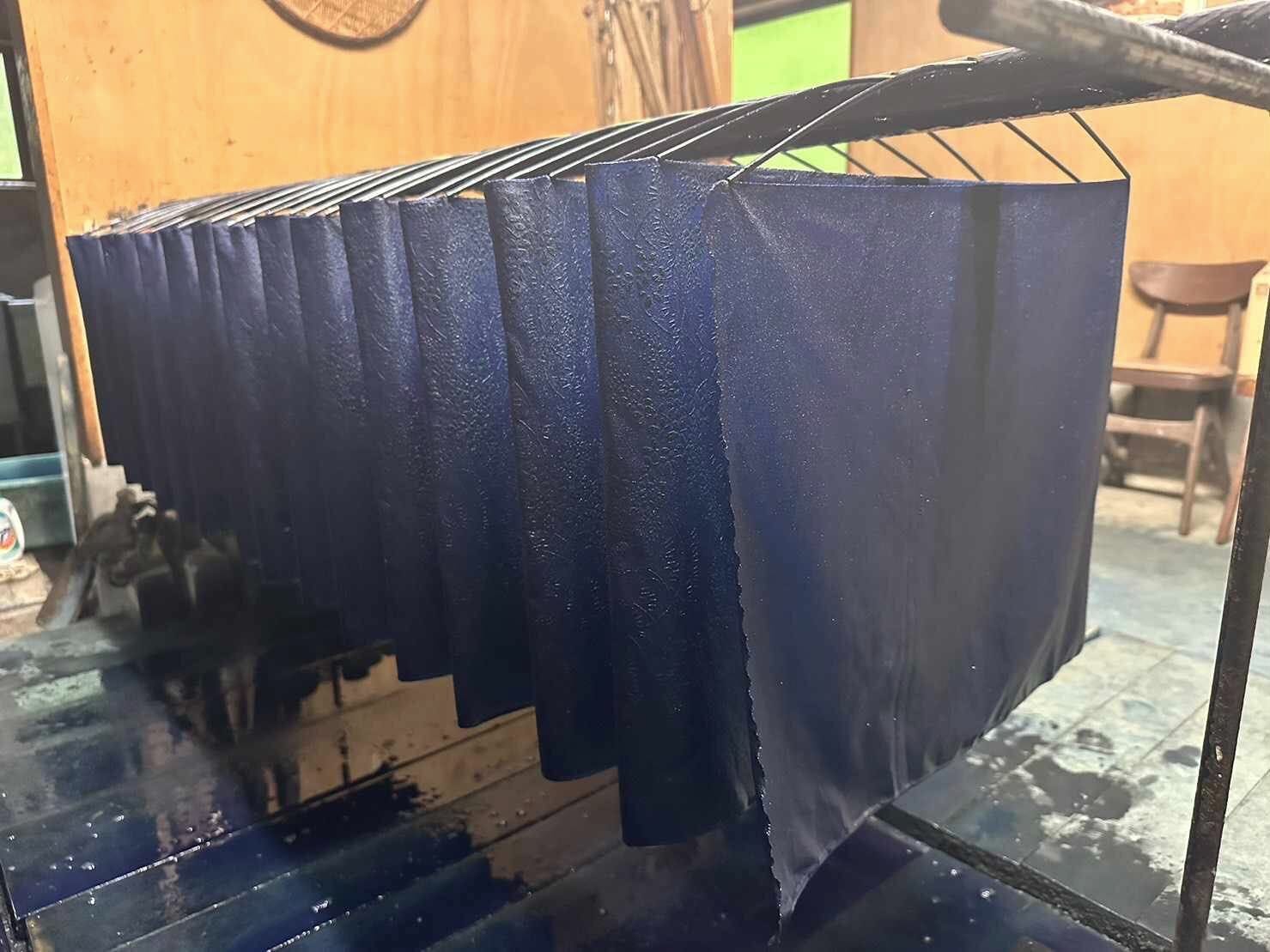 Indigo-dyed fabric raised out of the vat