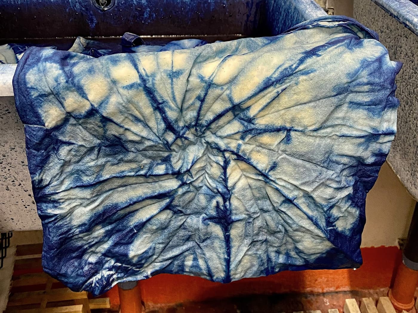 A dyed bundle opened out showing white starburst patterns on blue