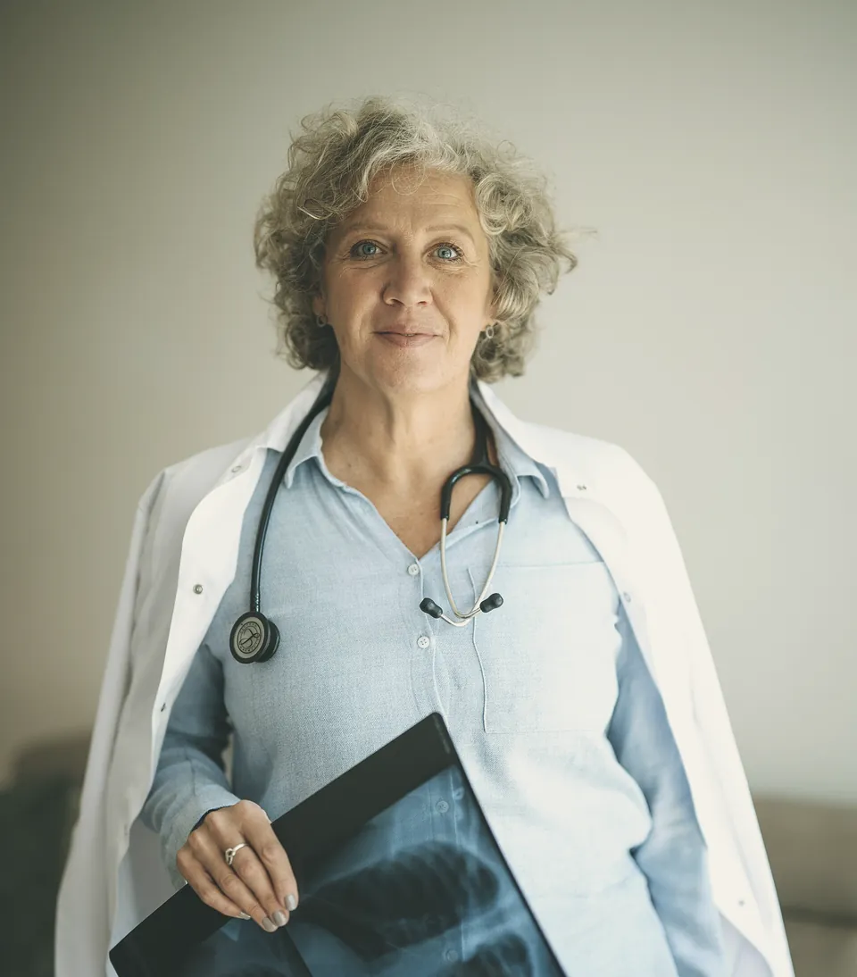 Dr Ruth Linden holding an X-ray in her consulting room.