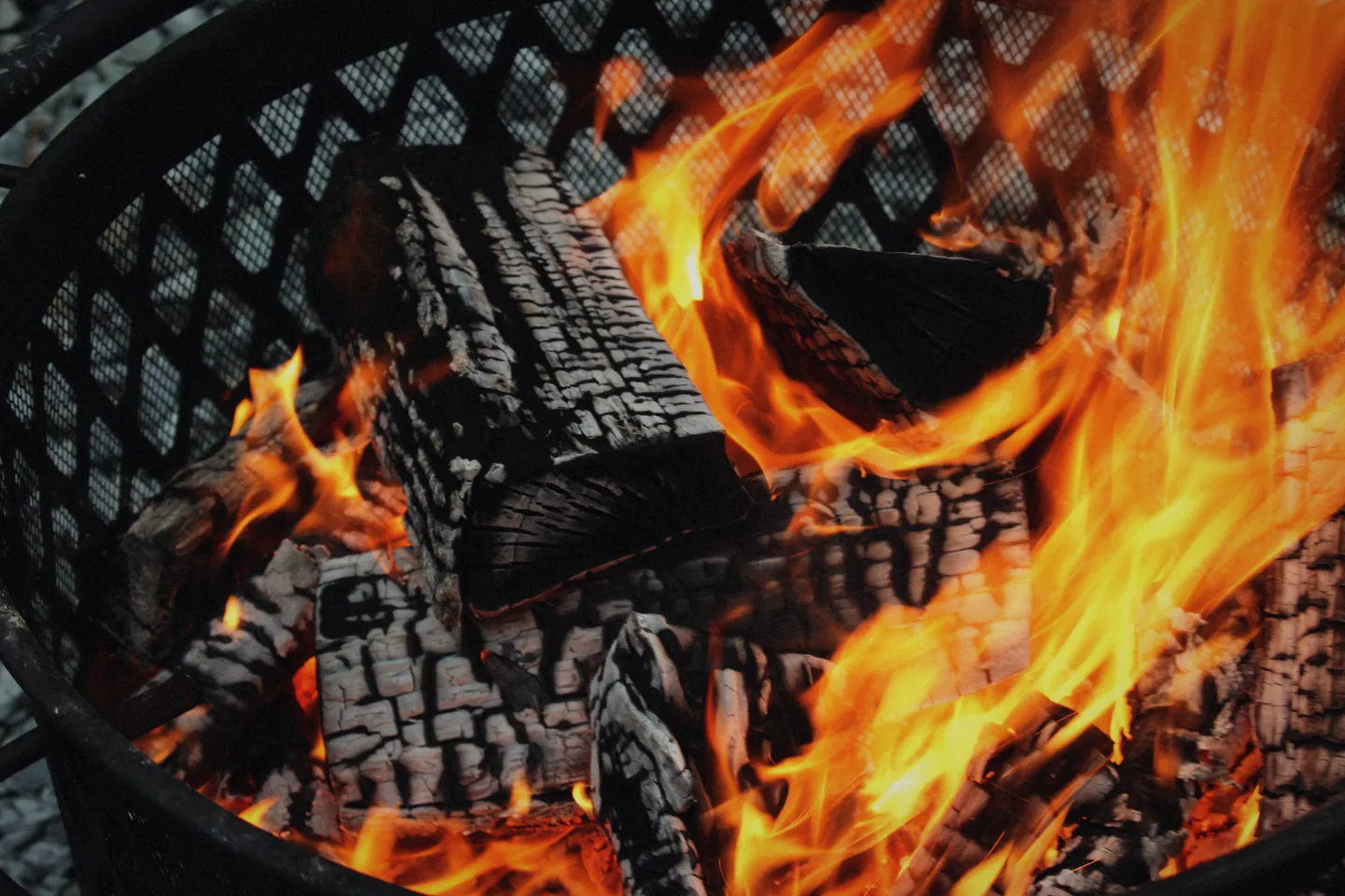 Logs burning in an iron fire basket