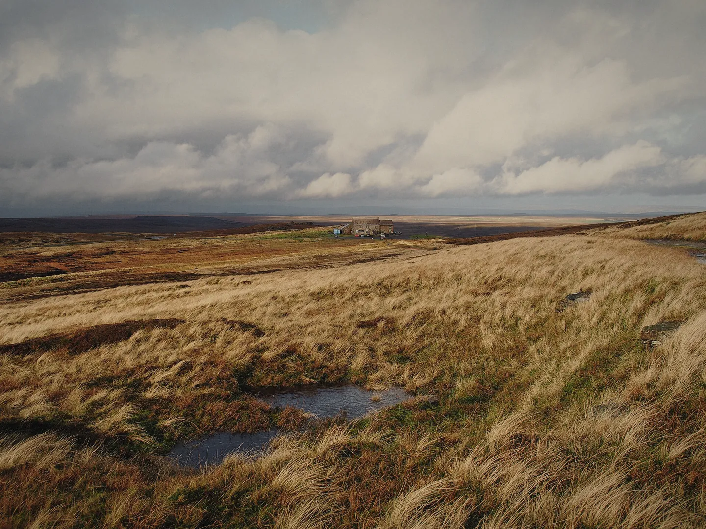 Open moorland with a peaty pool near Tan Hill under a big sky