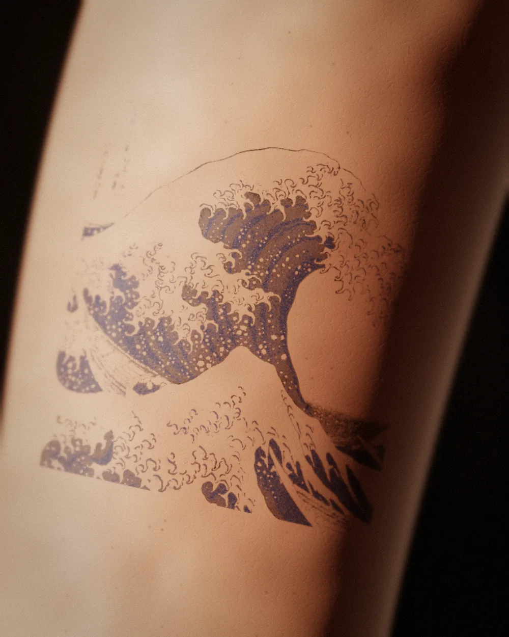 The wave tattoo, after Hokusai, c. 1831, on the upper arm, healed 10 months