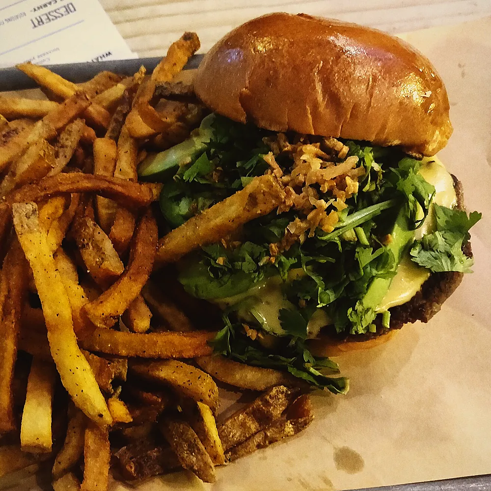 Smash burger and fries on paper