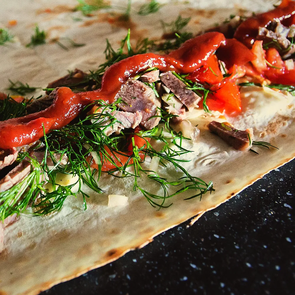 A wrap being filled on the counter