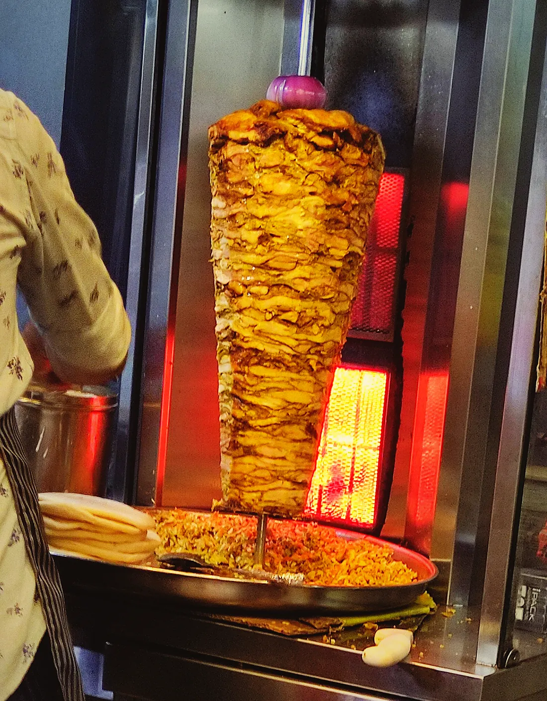 Chicken stack turning in front of the glowing burners