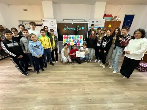 Grup de gimnaziu la Ziua Toleranței, cu roll-up-uri UE/Erasmus+ în sală